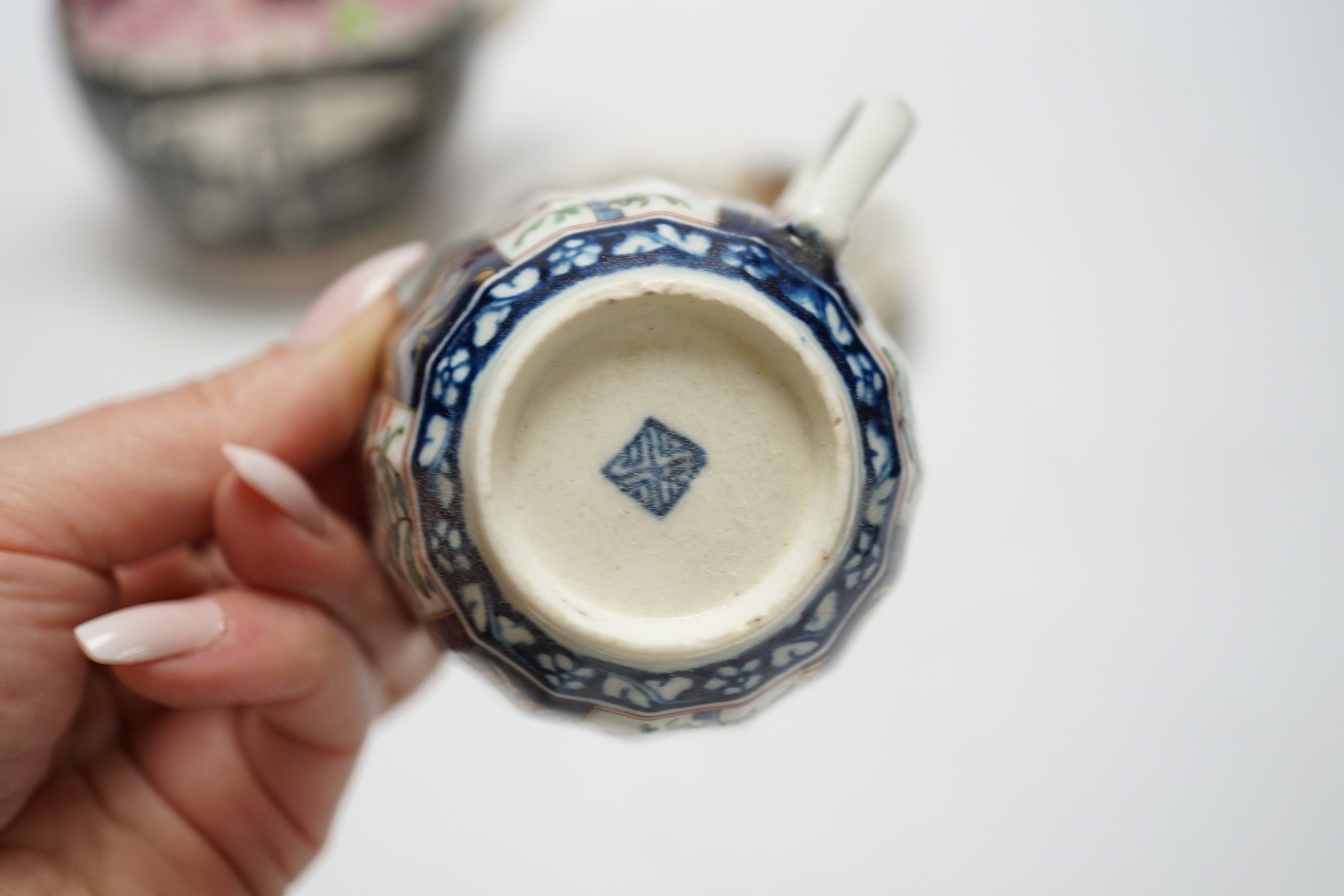 A Worcester Kakiemon pattern coffee cup and saucer, c.1780 and Gray’s Pottery pink lustre ‘’Iron Bridge Sunderland’’ jug, (3), 13cm